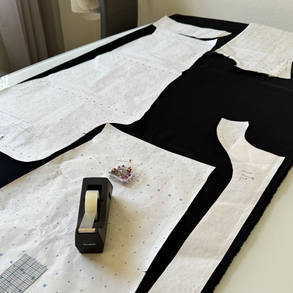 Fabric pattern pieces laid flat on cutting table with pins and tape measure — After Stilettos pattern correction