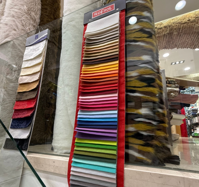 Interior of Ouro Têxteis fabric shop in Lisbon, bright and open with samples of fabric.
