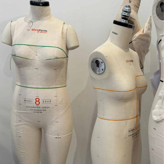 Two padded dress forms side by side in the Fashion School of Florida studio.