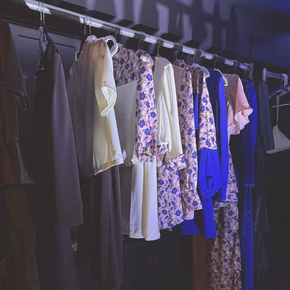 A rail of garments hanging backstage at New York Fashion Week.