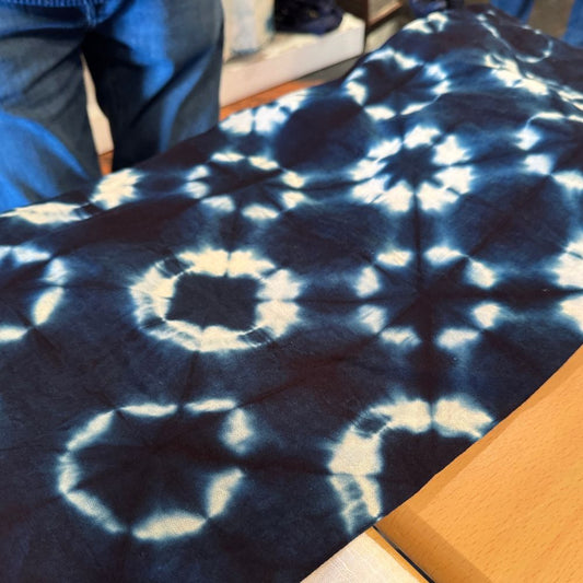 Close-up of shibori indigo dyed fabric with circular resist patterns — After Stilettos Three Weeks in Japan as a Maker