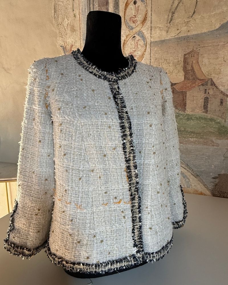 Handmade French couture jacket in ivory tweed with black braid trim, crafted by Nicola Grayling at After Stilettos — Italian workshop