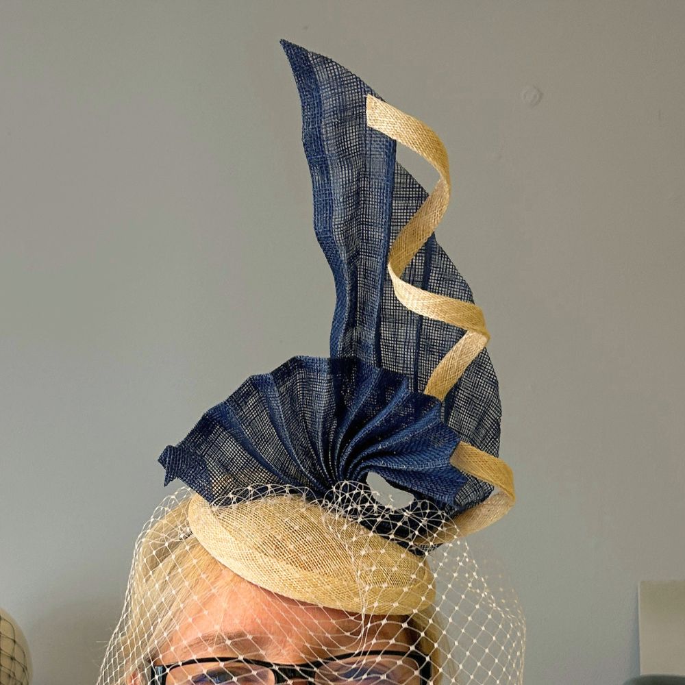Handmade fascinator with sinamay and birdcage veil created at a London millinery studio