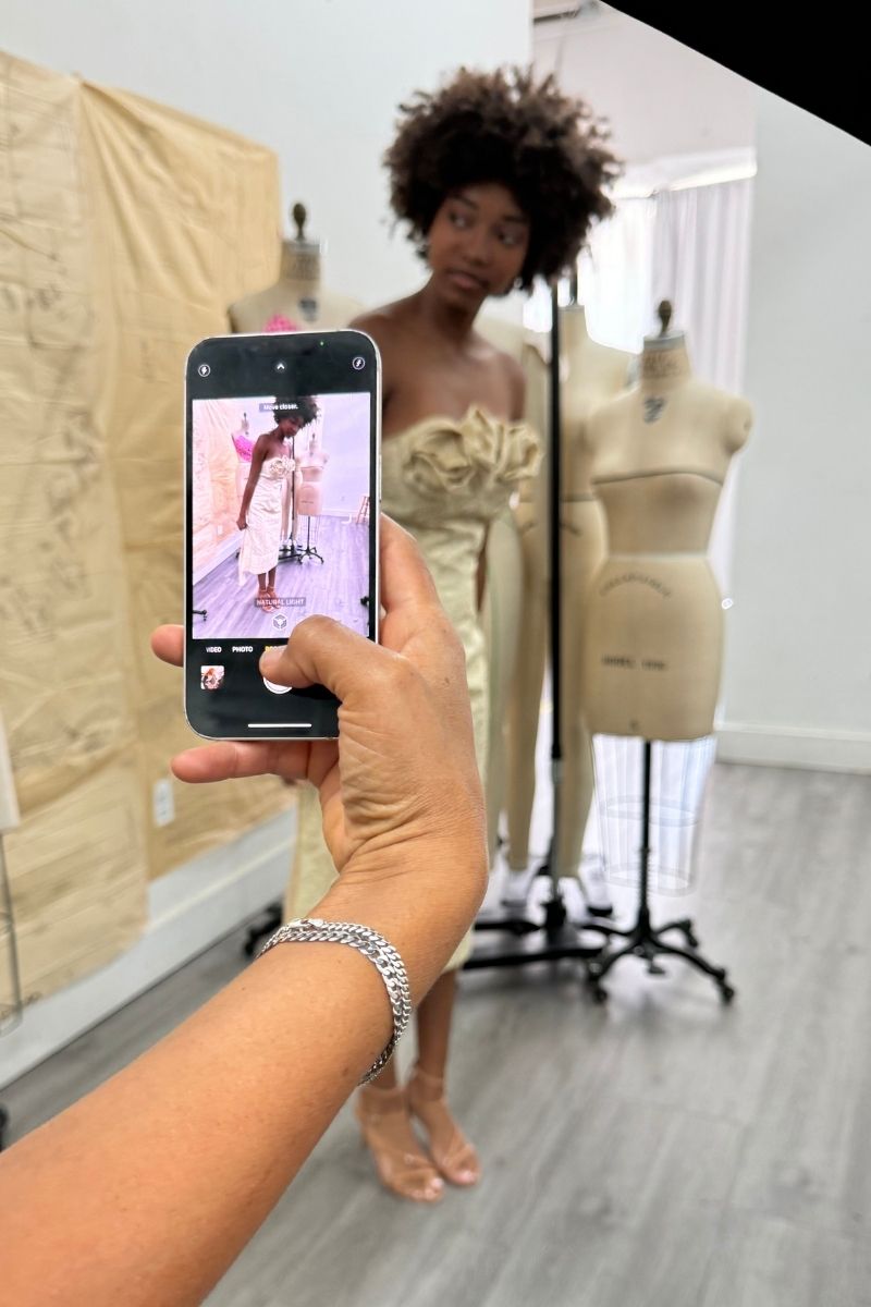 Behind the scenes at the After Stilettos atelier — Shadow Blossom gown captured on phone during fitting