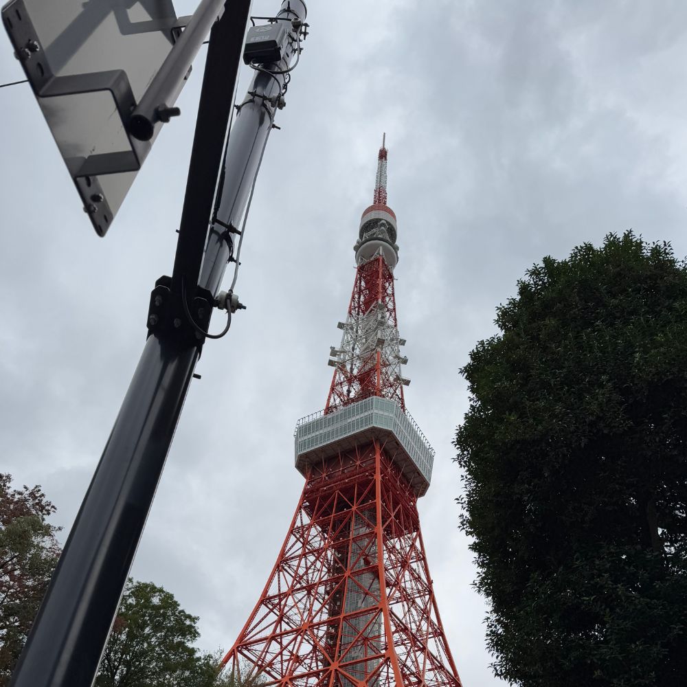 Street-level view of Tokyo Tower through urban buildings — After Stilettos Learning Through Making Craft Experiences in Japan